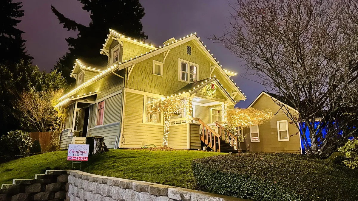Craftsman home decorated with warm white holiday lights