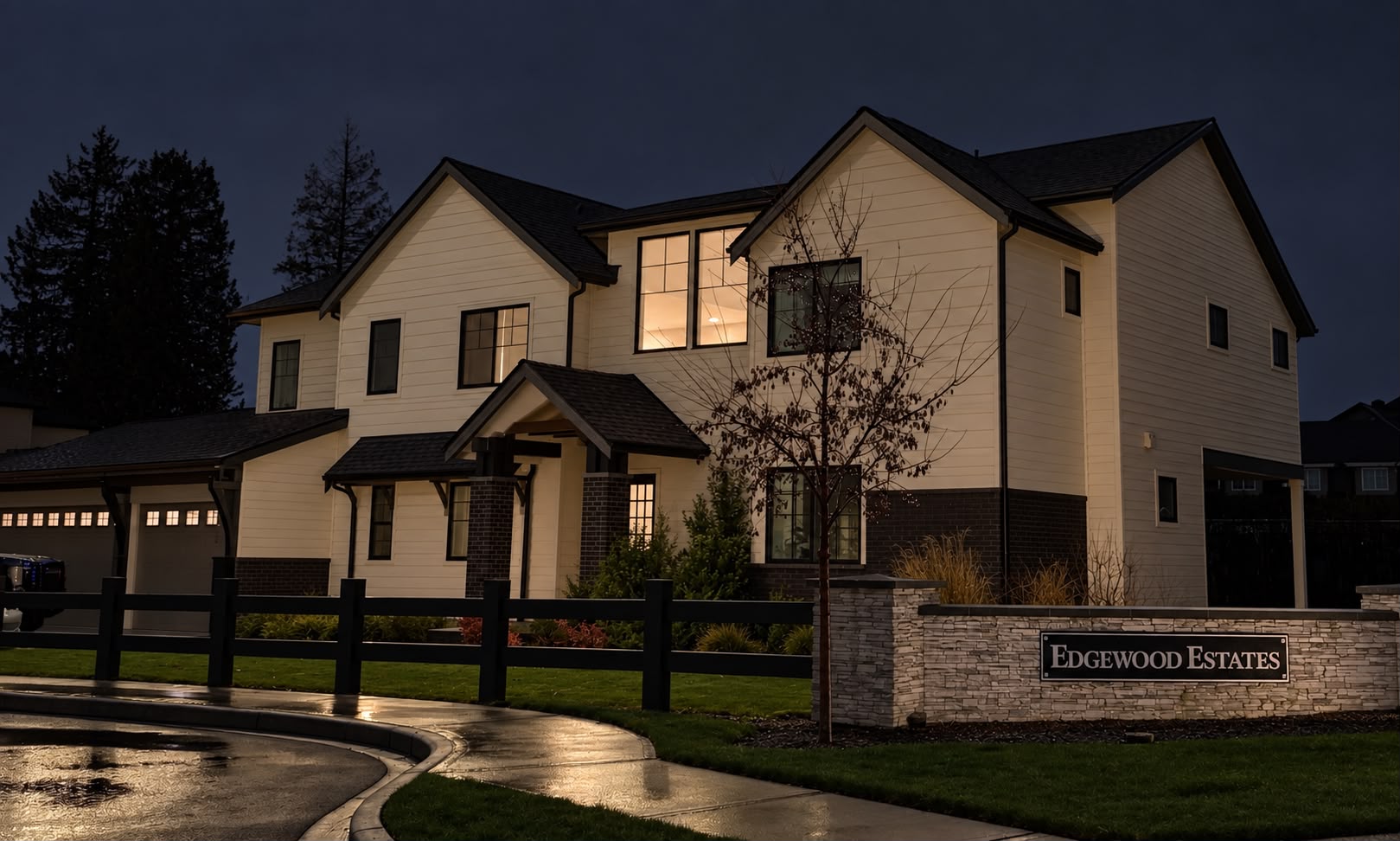 The same two-story home at night before lighting installation